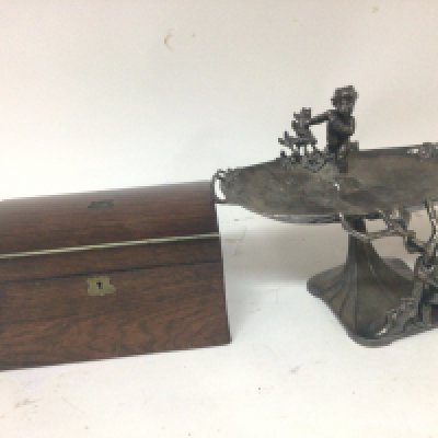 A Rosewood 19th century tea caddy with a hinged dome top and a WMF pewter stand with raised putti (damaged) (2)