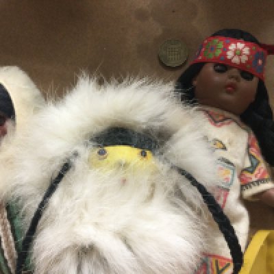 A collection of five dolls in the form of Native American.