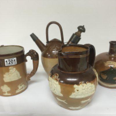 A group of Lambeth and Royal Doulton stoneware ceramics. Including a silver mounted puzzle jug no obvious damage (4) NO RESERVE