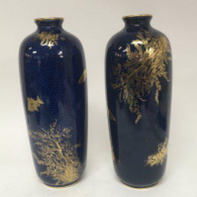 A Pair of George Jones and son ceramics vases decorated with applied gilt with fish and naturalistic foliage on a powdered blue ground. Marks to the base no obvious damage. Height 33cm.