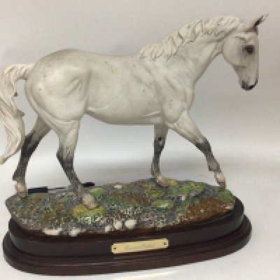 A Royal Doulton ceramic figure of Desert Orchid limited edition on a mahogany base. Hight 32cm no obvious damage