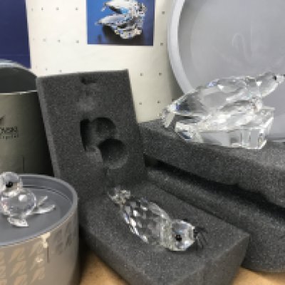 Three Swarovski seal figures including mum and pup on ice sheet, boxed