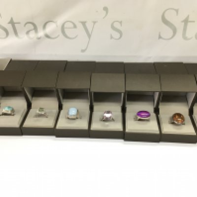 A collection of 8 assorted silver rings set with various stones. Postage B