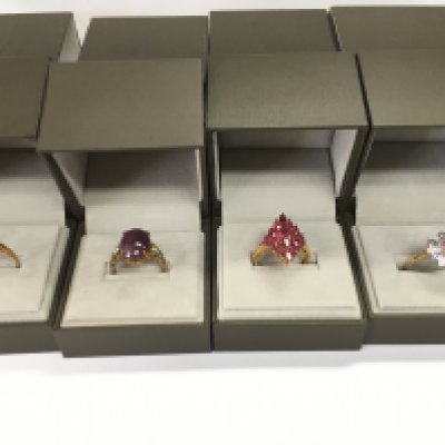 A collection of four 9ct gold rings set with assorted stones. 15.27g Postage B
