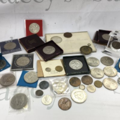 A collection of coins including British crowns, pennies , Netherlands liberation medal, Netherlands coins etc. postage category B