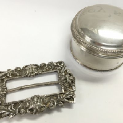 A circular silver hallmarked bead pill trinket box with an 1890s Mappin & Webb buckle . 107.8g Approx total. postage category A