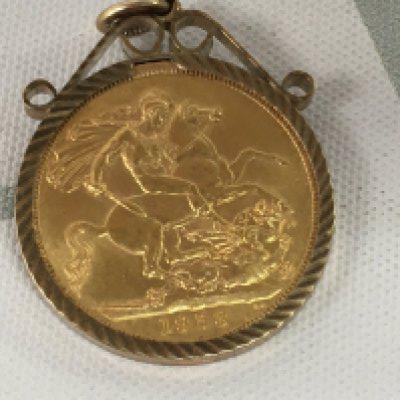 A gold 1958 full sovereign in mount .