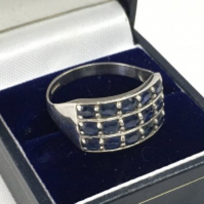 A 9ct white gold ring set with blue sapphire stones, size Z. Total weight 4.5g. Postage category A