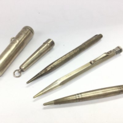 A collection of three silver hallmarked pens and two silver cigar / cigarette holders. Postage category A