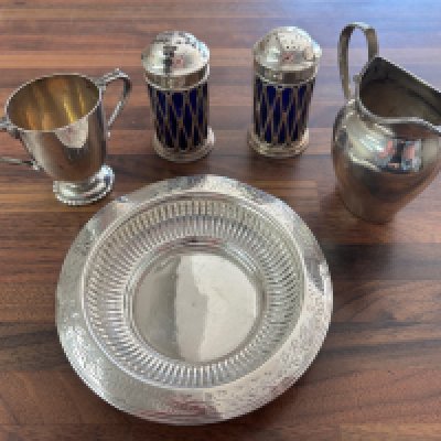 A collection of silver items comprising cruets, jug, etc. Shipping category B.