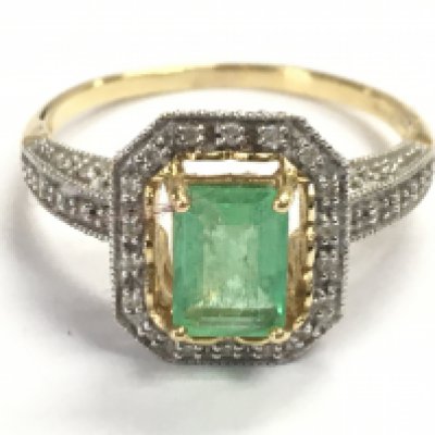 A 9 carat gold emerald and diamond shard ring , size P/Q. 4.4g total weight. Postage category A