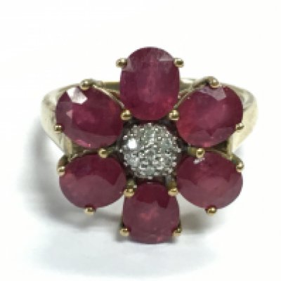 A 9ct gold ruby and diamond shard flower ring , 4.8g total weight. Postage Category A
