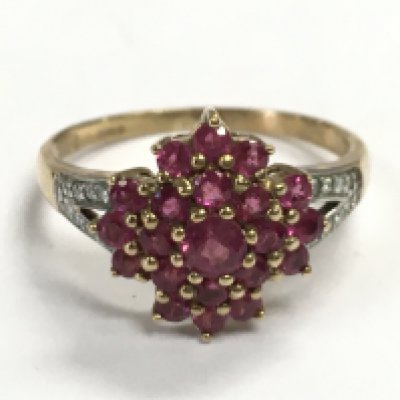 A 9 carat gold ruby and diamond set ring, size P. 2.8g Postage category A