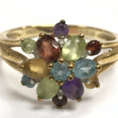 A 9 carat gold multi stone ring. 3g . Size Q.Postage category A
