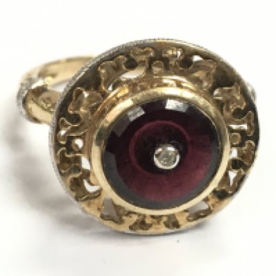 A 9 carat gold ruby ring inset with a diamond stone size S. 5.8g postage category A