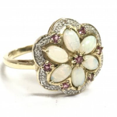 A 9 carat gold opal & ruby floral ring, size P. 3.8g total weight. Postage category A