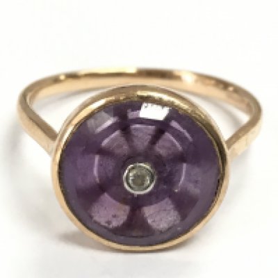 A 9 carat gold Amethyst with a single diamond stone ring, size S. 3.5g total weight. postage category A