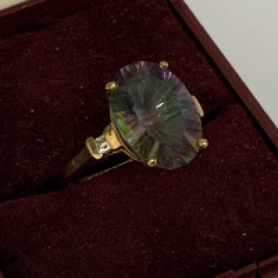 A 9ct gold ring set with a large mystic topaz and surmounted with baguette cut diamonds to shoulders, Size N. (A)