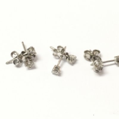 Three pairs of 9ct white gold diamond solitaire earrings. 2.34g