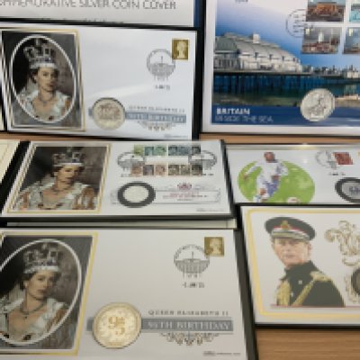 Harrington & Byrne coin and stamp folders. Some include silver coins. (A)