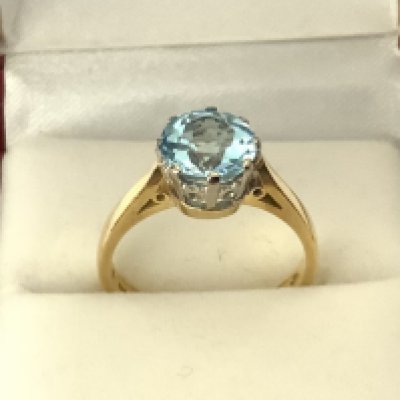 A large 18ct yellow gold Fancy blue topaz ring, Size N. (A)