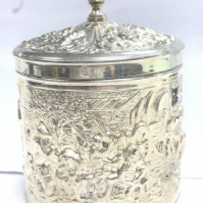 An ornate silvered container , marked DE.HH.90. Postage category B