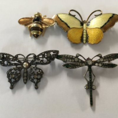 A collection of four butterflies and dragonflies brooches , including enamel .