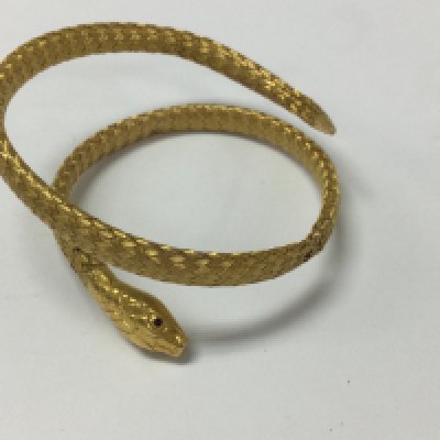 A gold bangle n the form of a serpent with rubie eyes .17 grams.