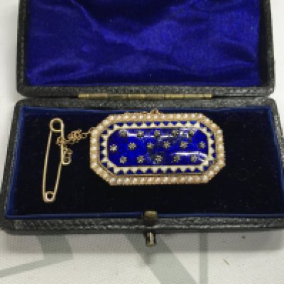 A gold 19th century enamel brooch set with diamond chips. (Unmarked).
