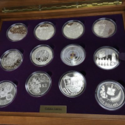 A sterling silver golden jubilee coin set containing 24 coins in nice wooden case. Postage B