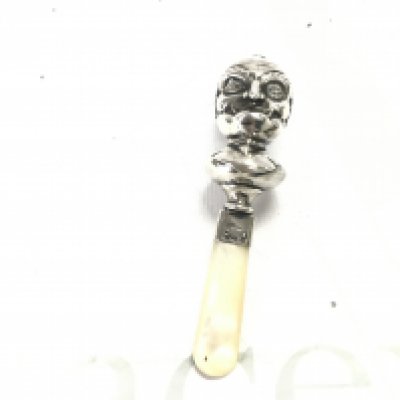 A hallmarked silver punch rattle. 50.53g Postage B