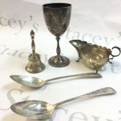 A collection of silver hallmarked items including a pair of silver fruit serving spoons marked Edinburgh 1796, gravy boat , Goblet and a bell. Total weight approximately 510g Postage category B