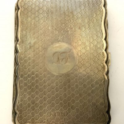 A hallmarked silver engine turned and leather lined pocket notebook. (A)