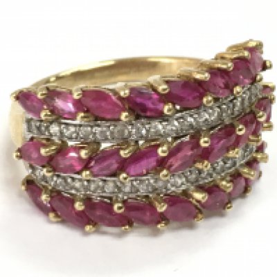 A 9 carat gold ruby and diamond set three row band ring . 5g total weight. Postage category A