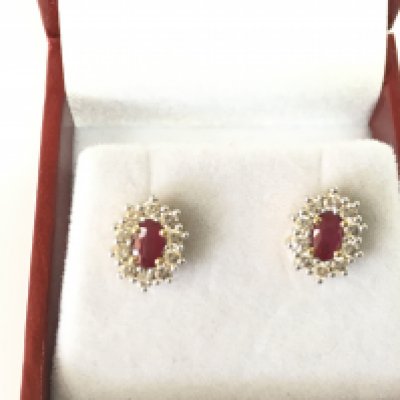 A pair of 9ct yellow gold oval ruby and diamond cluster studs. Rubies 0.48ct and diamonds 0.53ct. Postage B
