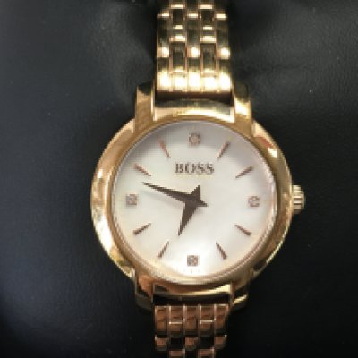A ladies Hugo boss watch with MOP dial. Comes with box. Postage B