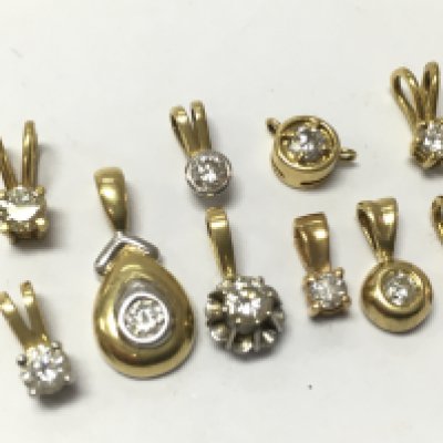 A collection of 18ct yellow and white gold pendants set with diamonds , 7.45g . Postage category A