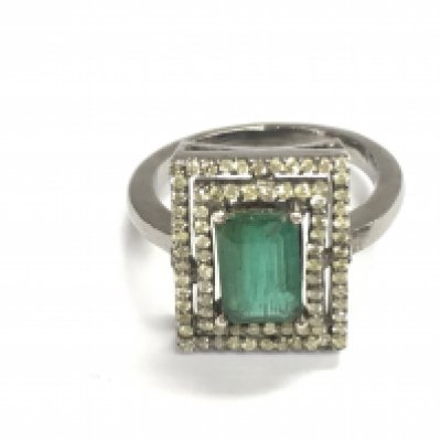 A diamond and emerald ring. Size N and 4.9g Postage B