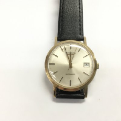 A 9ct gold cased gents Longines automatic wrist watch on black leather strap. Winds and runs. Postage B