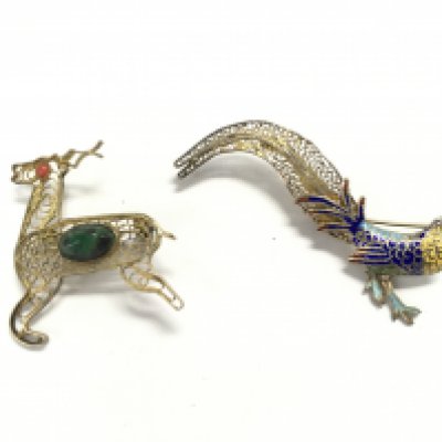 Two silver filigree brooches the deer is set with polish stones and the others is an vintage Art Deco style enamel peacock brooch.