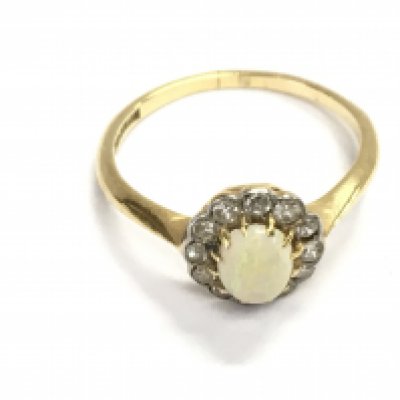 An 18ct gold diamond and opal ring. Size M and 2.13g. Postage A