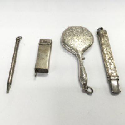 A collection of silver items including a small silver hand mirror pencils etc Postage B
