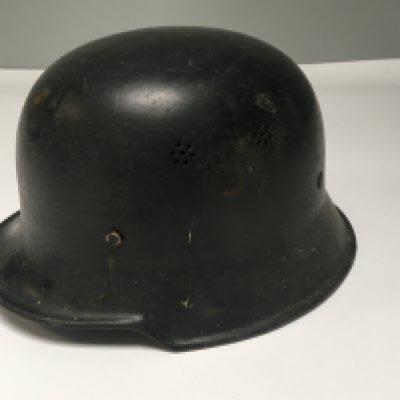 A Genuine German II world war Third Reich Police helmet black finish folded edge and with original liner.