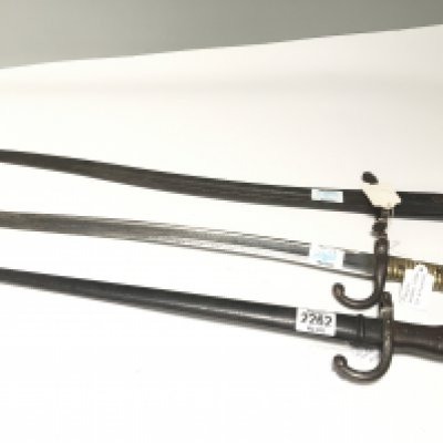 A British 1856 pattern Yataghan bayonet numbered 107 with further small stamp marks on the blade no scabbard a French 1866 pattern bayonet and an 1877 pattern bayonet with scabbard (3)
