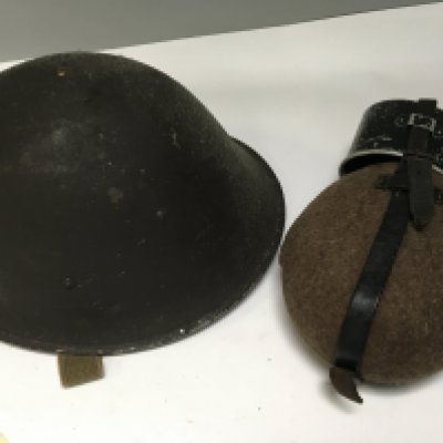 A British Military issue combat helmet worn in Belfast late 1960-70 and a military issue water bottle (2)