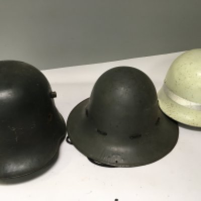 A German imperial I world war steel combat helmet one other helmet and a post war German issue helmet white with a high visual reflective band (3)