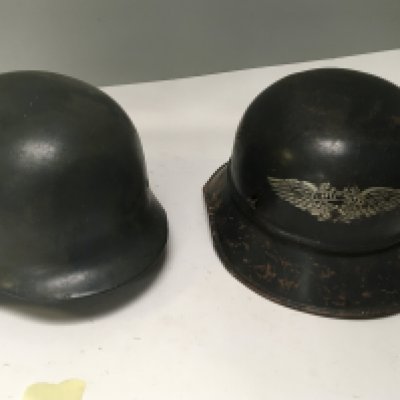 A German Third Reich Luftwaffe double decal steel combat helmet possible an earlier M35 pattern no liner and a Luftschutz Czech helmet with Mauser decal (2)