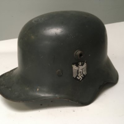 A rare German Transitional Cavalry or Telegraphists helmet. The M-18 helmet has a shaped edge to allow the cavalry soldiers to hear orders whilst in a battle charge. This is a rare genuine example of a transitional helmet used in both I and II world war the helmet with German Third Reich decals folded edge and unusual white liner.