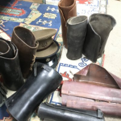 A collection of military hats including a Malay States Volunteer Rifles officers cap and a Middlesex Reg officers cap and leather leggings. This lot cannot be posted