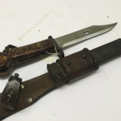 An Early Example of an AK47 bayonet with leather attached frog the cross guard stamped AEP 1059. With Bowie type blade and saw edge. NO RESERVE